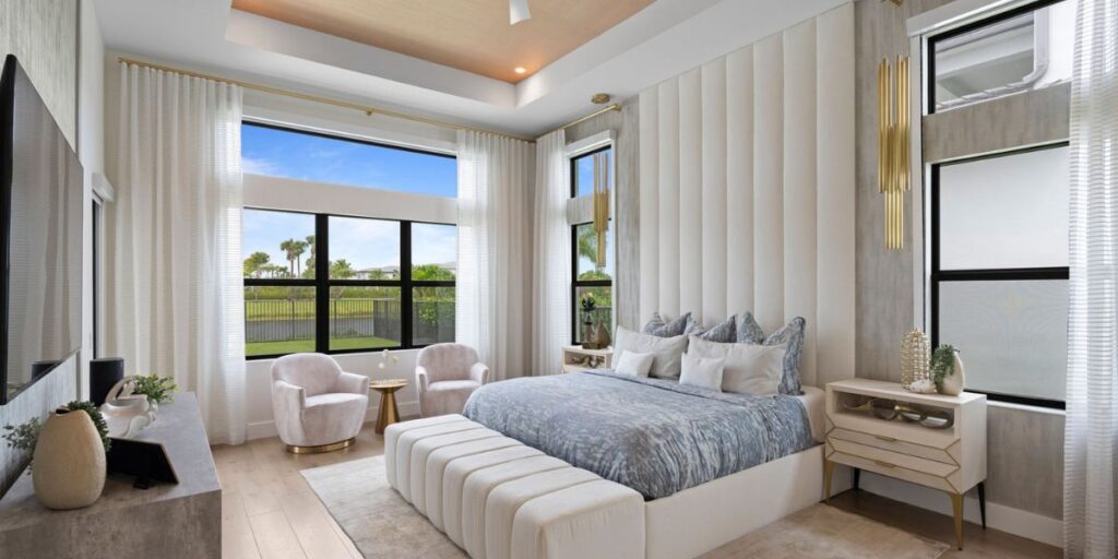A luxuriously appointed bedroom with plush furnishings and a panoramic window view.