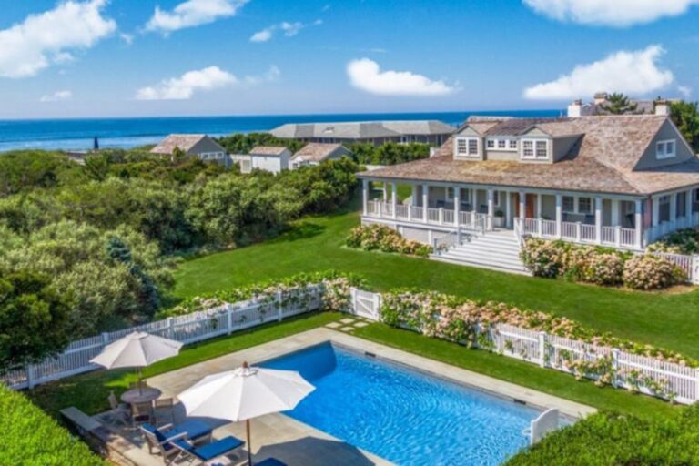 Traditional Hamptons beach house with a swimming pool and ocean view.