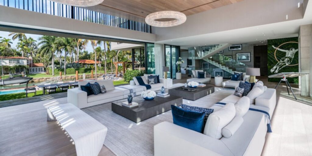 Open-plan living room of a luxury home with a view of the waterfront.