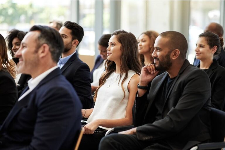 A diverse group of professionals attentively participating in a business conference.