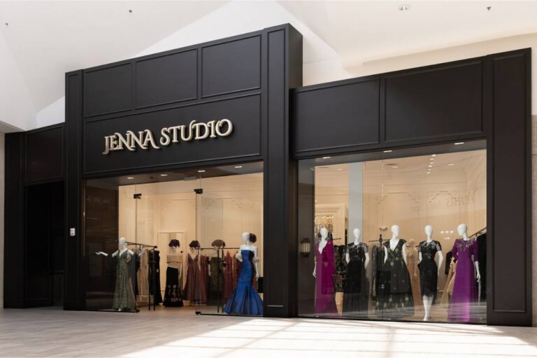 Elegant storefront of JENNA STUDIO with mannequins displaying designer dresses.