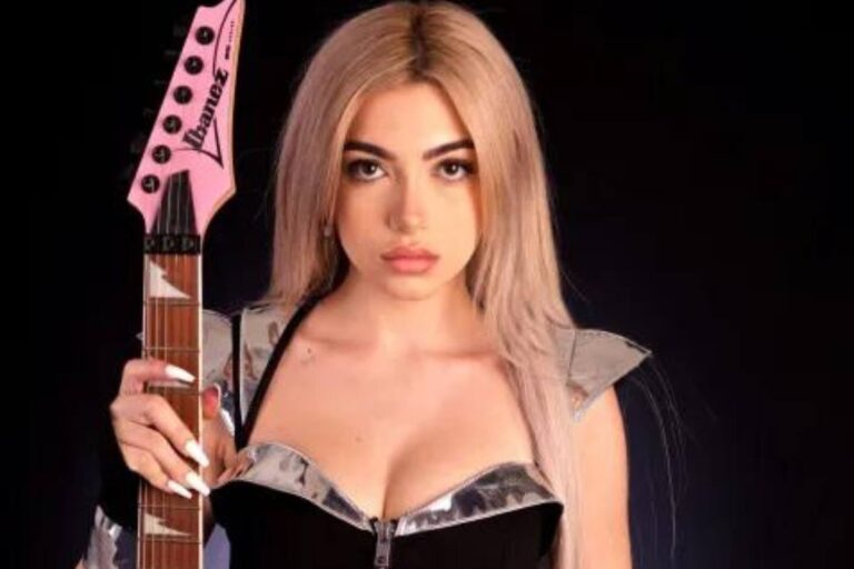 Sophia Gonzon holding a guitar.