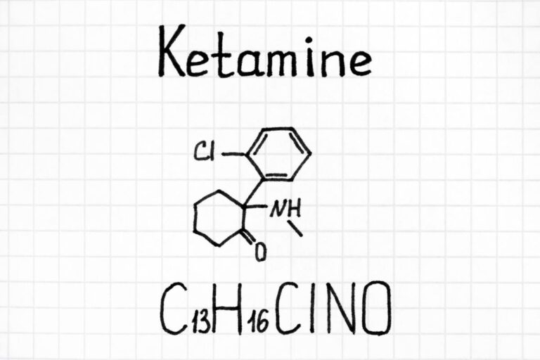 Hand-drawn chemical structure of Ketamine on grid paper with the molecular formula C13H16ClNO.