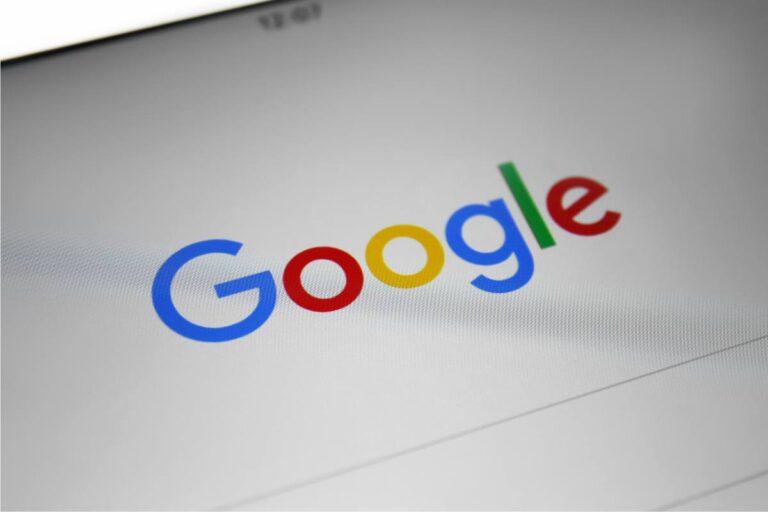 Close-up view of the Google homepage on a computer screen, with the company's colorful logo in sharp focus.