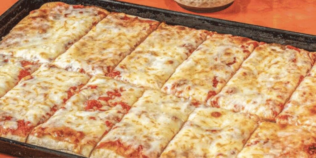 Rectangular pan of sliced cheese pizza with a crispy golden crust.